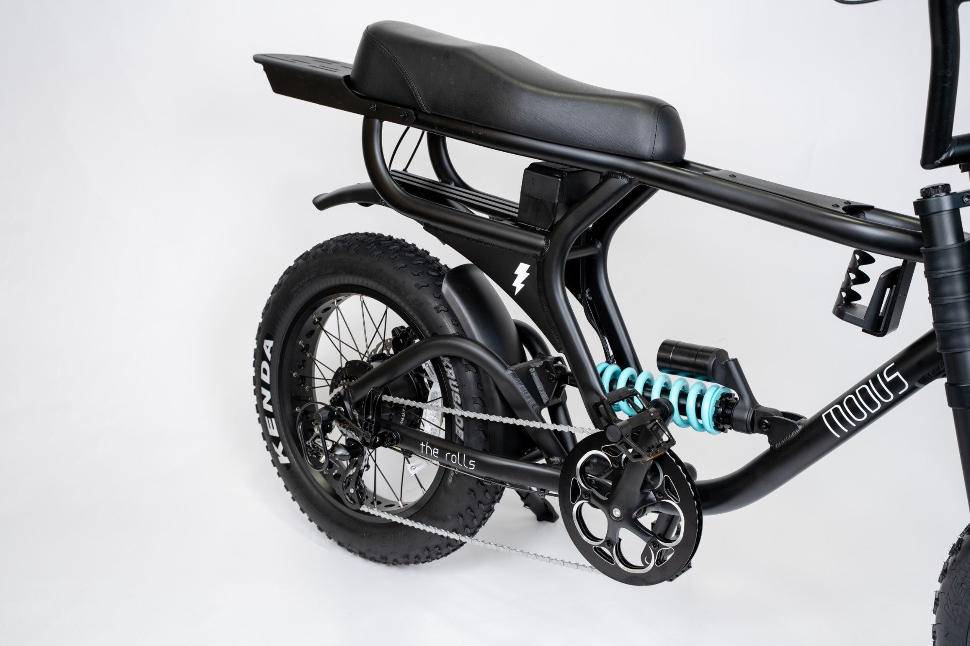 The Rolls rear three quarter view showing the two rider bench, rear rack and teal DNM coil